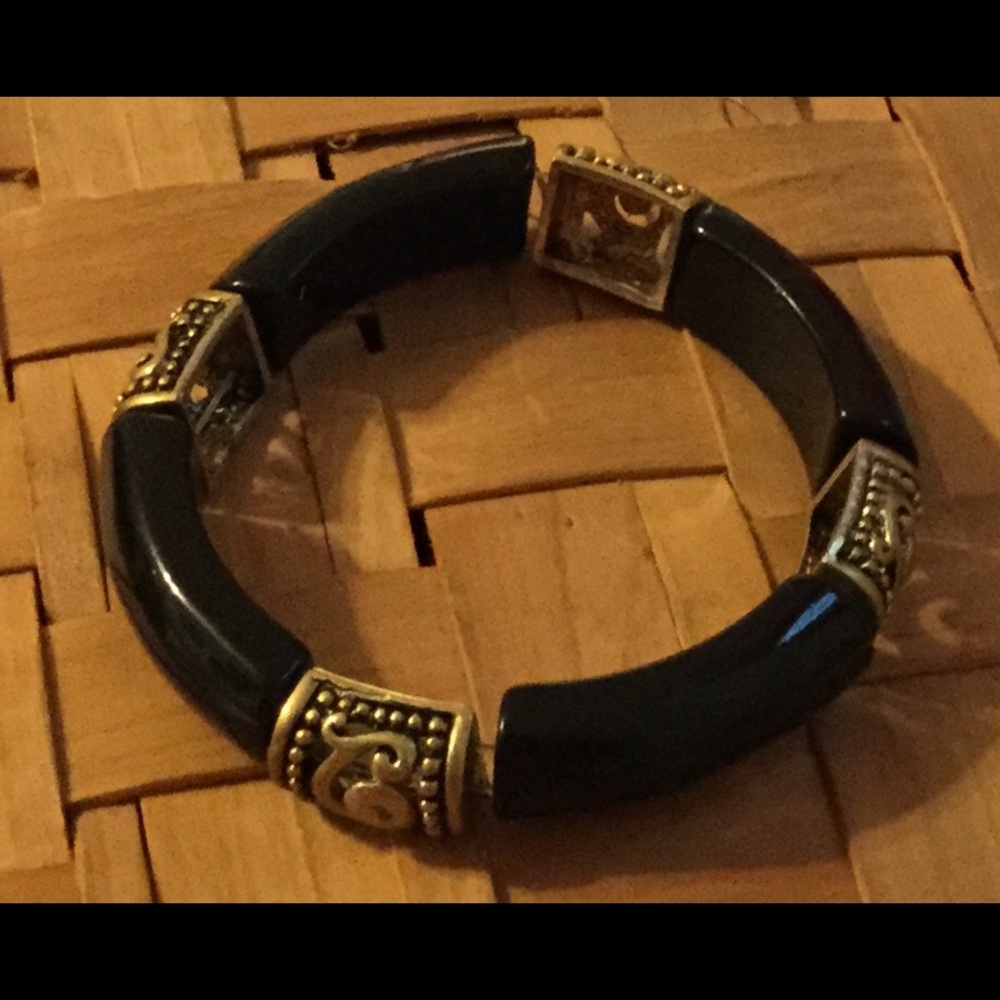 Elastic black and gold colored bracelet